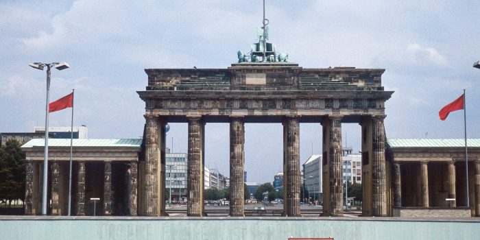 Historic image from July 1980: A look from West Berlin over the Berlin wall to Brandenburg Gate and East Berlin. Sign with "Caution: You are leaving West Berlin" in the foreground. Scanned Slide. Historic image from July 1980: A look from West Berlin over the Berlin wall to Brandenburg Gate and East Berlin. Sign with "Caution: You are leaving West Berlin" in the foreground. Scanned Slide.